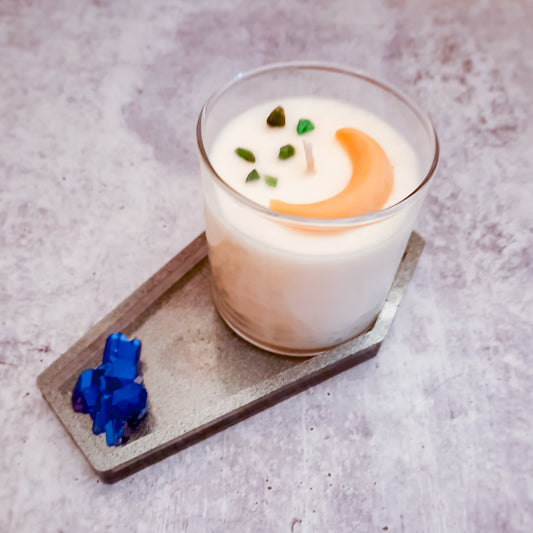 handcrafted vegan soap bar organic oils
on wood soap dish
with moon background spooky dark apothecary style
in bathroom on tile