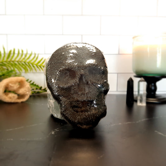 skull bath bomb with candle and fern