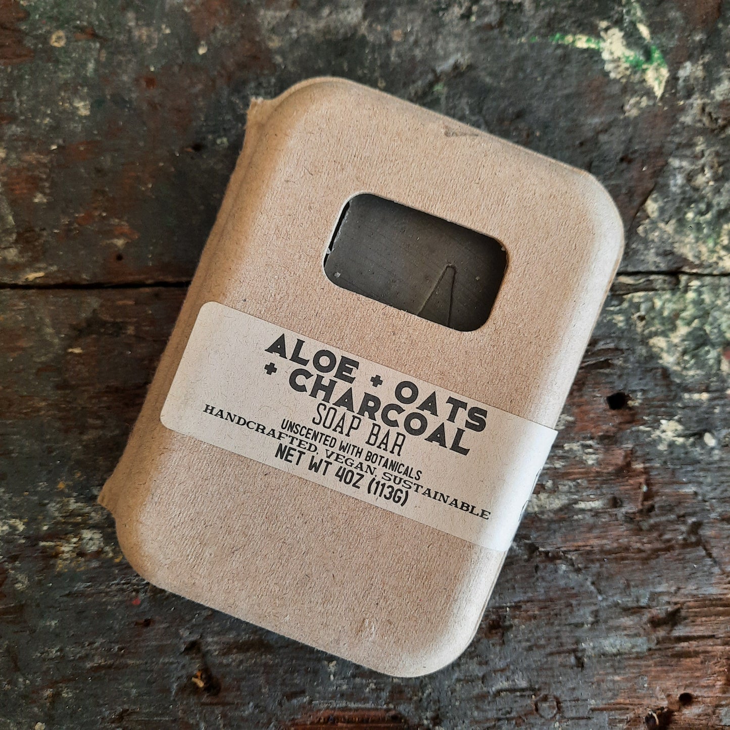 handcrafted vegan soap bar organic oils
on wood soap dish
with moon background spooky dark apothecary style
in bathroom on tile