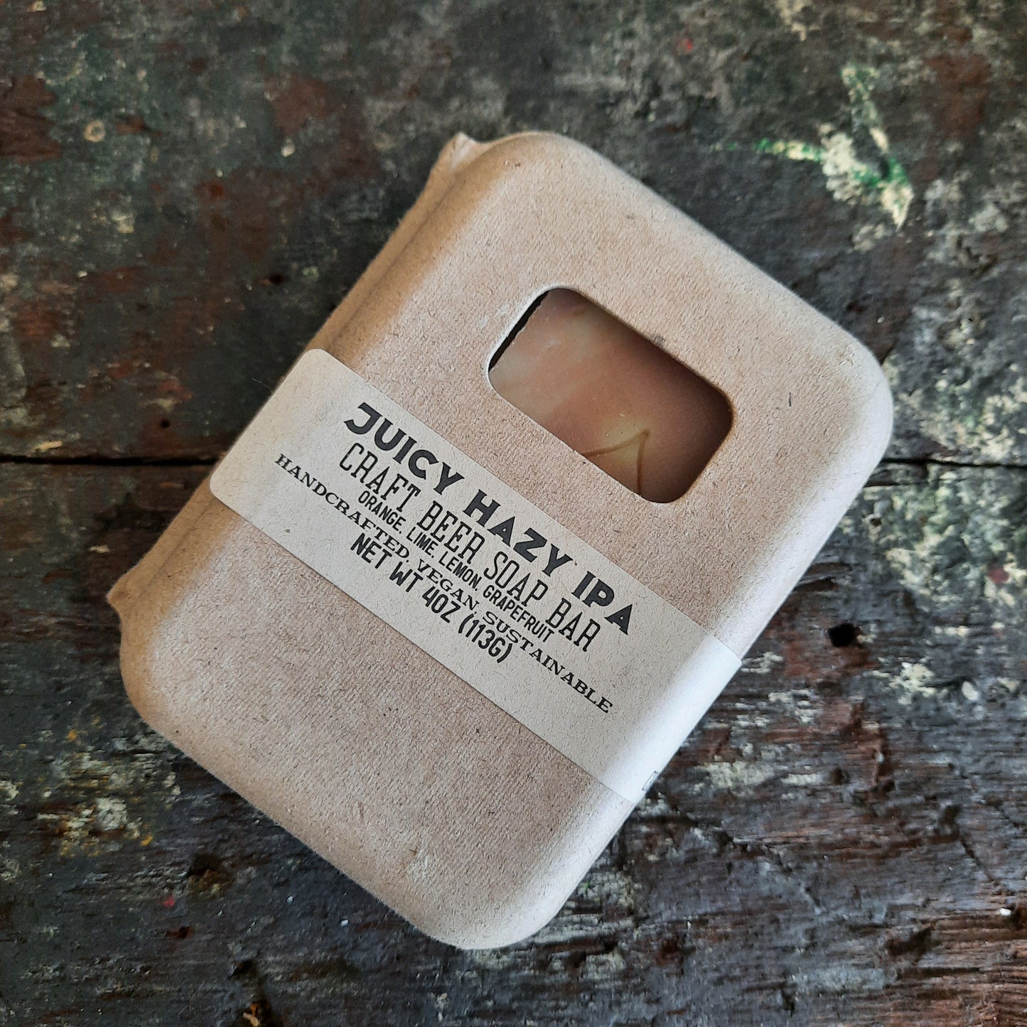 handcrafted vegan soap bar organic oils
on wood soap dish
with moon background spooky dark apothecary style
in bathroom on tile