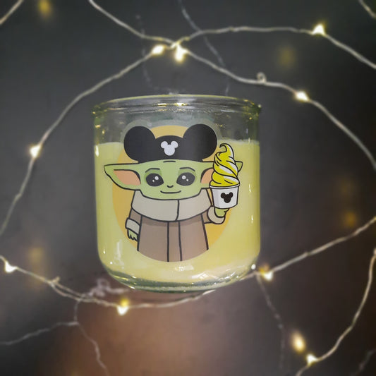 flatlay on black of yellow candle with fairy lights