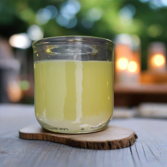 yellow candle citronella on a table outside in summer patio