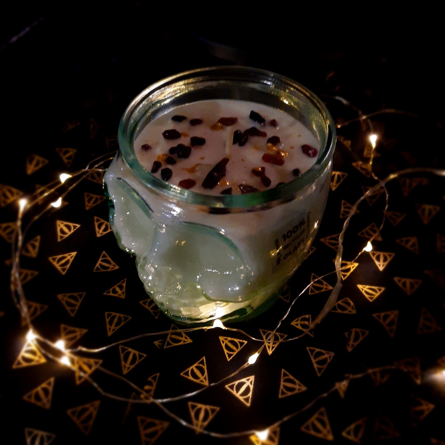 dark moody photo of skull candle with fairy lights