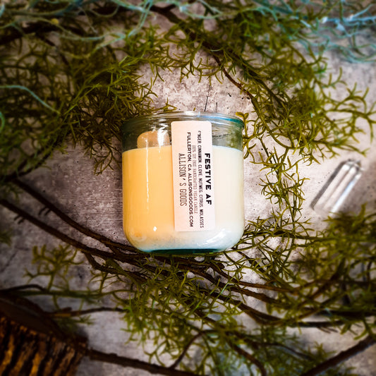 flat lay of sustainable vegan candle jar on cement with moss