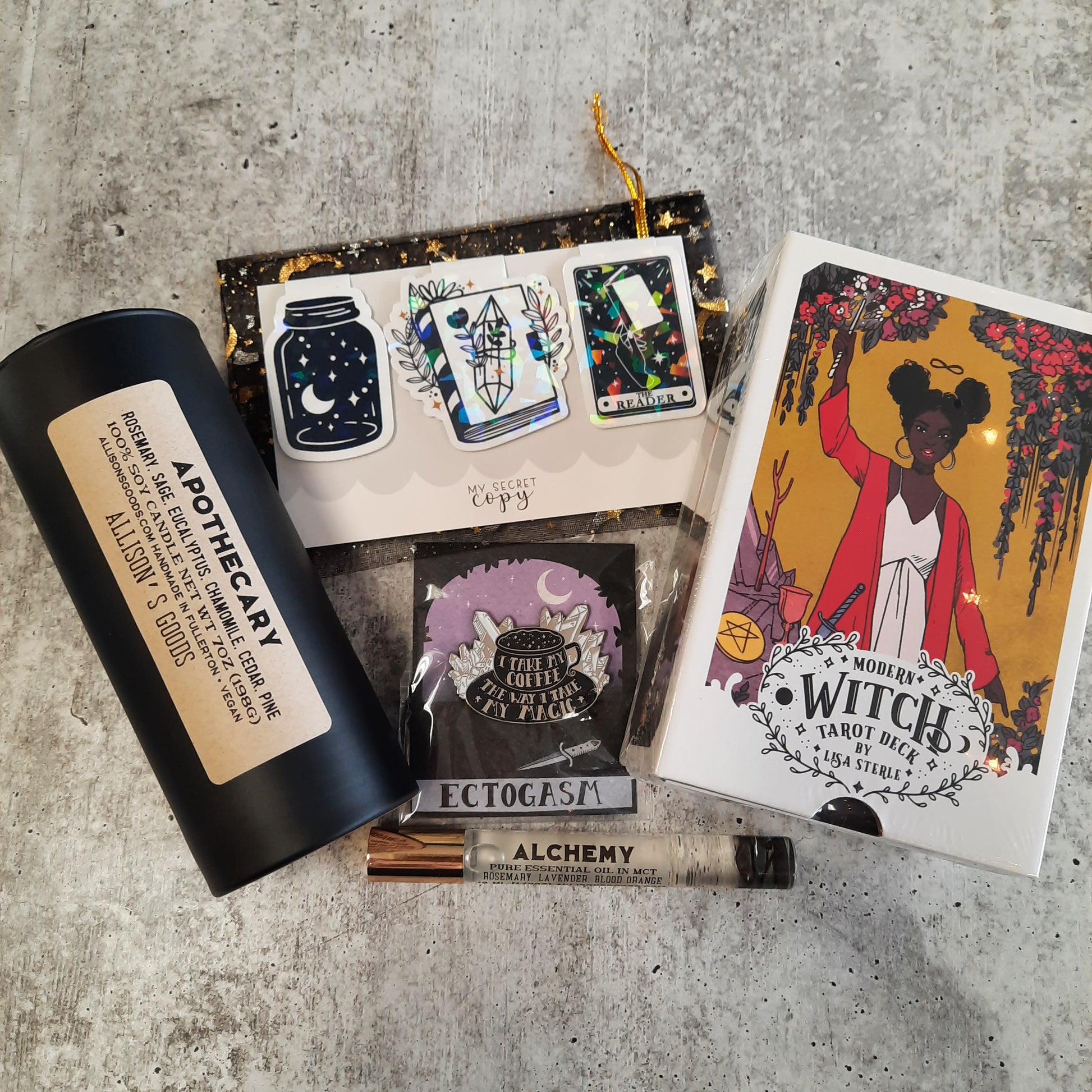 cement flatlay of candle with tarot cards and enamel pin