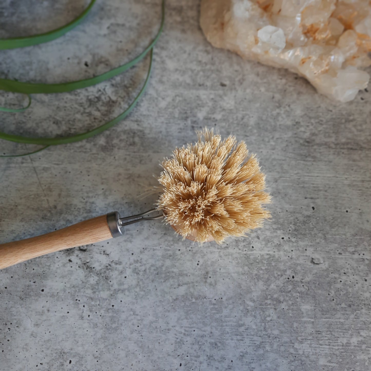 flatlay of sustainable dish brush with crystals