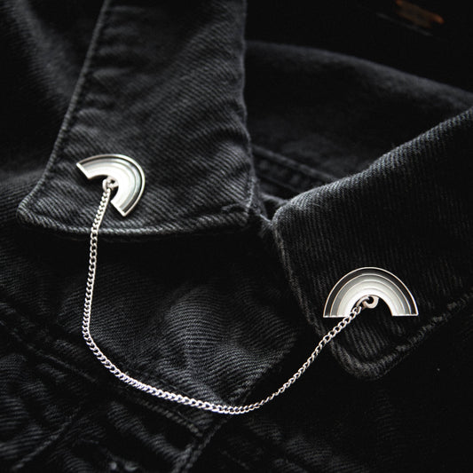 black jean jacket with rainbow collar pins
