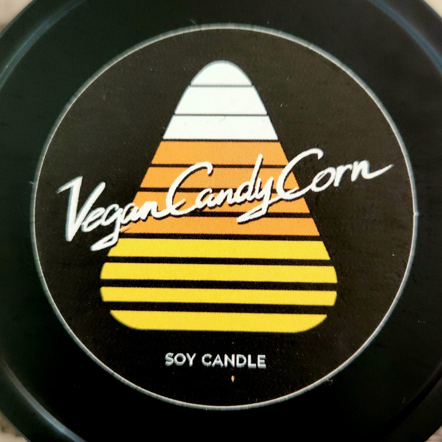 close up of vegan candy corn logo tin soy candle lid